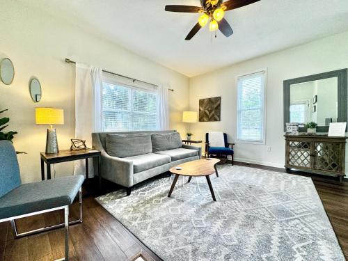 a living room with a couch and a ceiling fan at Loft On Landess in Marion