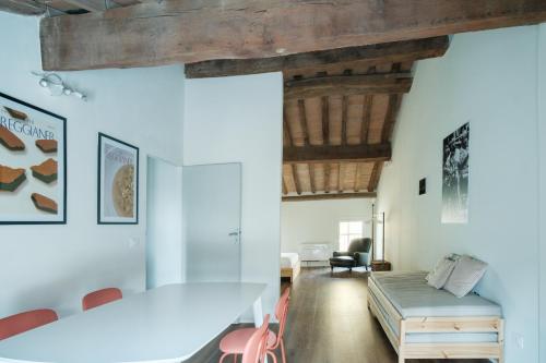 a dining room with a table and a couch at Blasmatorti Suite in Reggio Emilia