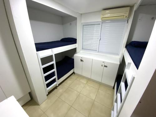 Ένα ή περισσότερα κρεβάτια σε δωμάτιο στο Hotel Compartilhado Ohmvue Floripa