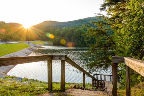 a view of a lake with a wooden bridge at Alpine Retreat in Helen