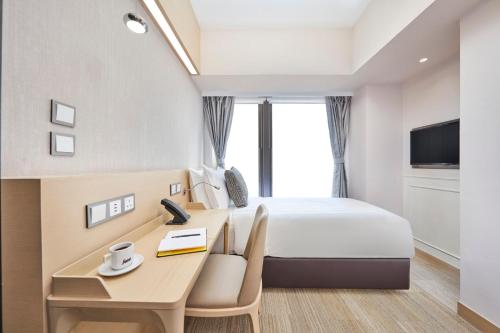 a hotel room with a bed and a desk at Y Hotel Hong Kong in Hong Kong