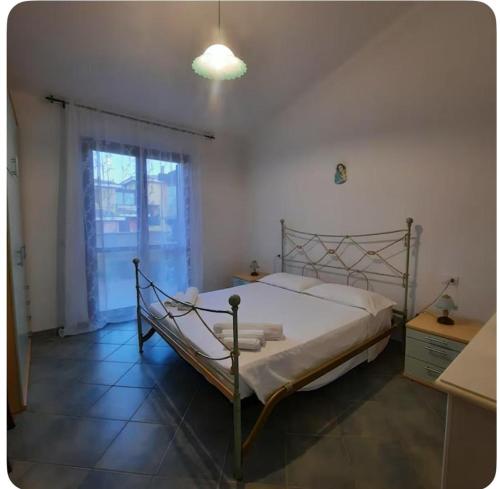 a bedroom with a bed and a window at Casa Bella Vista in Villasimius