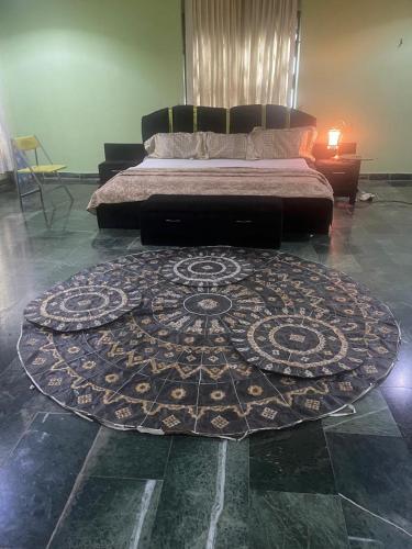 a bedroom with a bed and a rug on the floor at Platinum Palace Home in Benin City