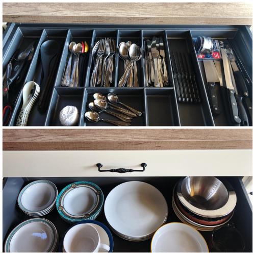 a drawer filled with dishes and utensils at Town center duplex with lift in Clonakilty
