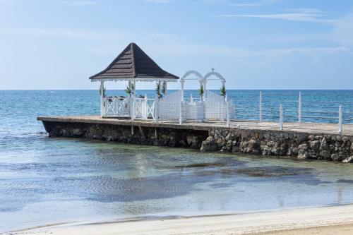 a pier with a wedding reception on the beach at Grand Muthu Runaway Bay Club Caribbean in Runaway Bay