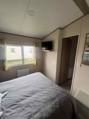 a bedroom with a large bed and a window at 149 Northfield in Ulrome