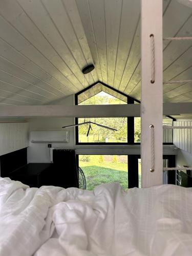 a bed in a room with a large window at Bliss Cottage in Slavske