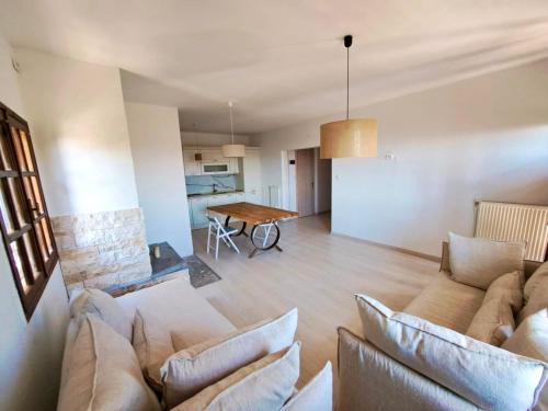 a living room with a couch and a table at Villa Elena - Renovated Gem with Stunning Sea Views in Neos Marmaras