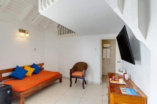 a living room with a couch and a tv at Grand Muthu Runaway Bay Club Caribbean in Runaway Bay