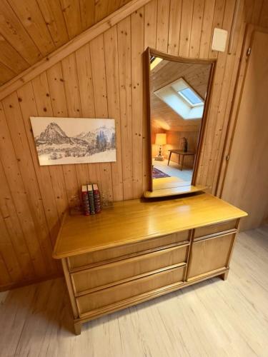 a dressing table with a mirror in a room at Historic Lakeview Swiss Chalet near Interlaken in Niederried