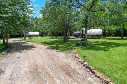 a dirt road in a park with trees at Secluded Luxury Wagon with Pond, King Bed, Full Bath, Patio in Montgomery