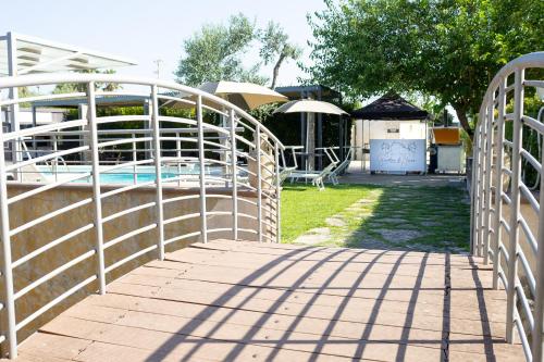 a wooden walkway leading to a swimming pool at Bed & Breakfast Giardini Di Marzo in Lecce