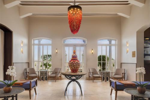 a lobby with chairs and a table and a chandelier at Ermita Cartagena, a Tribute Portfolio Hotel in Cartagena de Indias