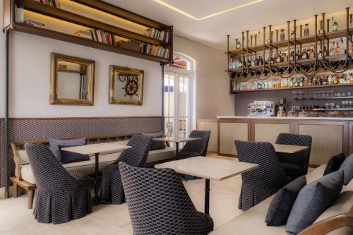a restaurant with tables and chairs and a bar at Ermita Cartagena, a Tribute Portfolio Hotel in Cartagena de Indias