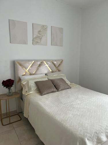 a white bed with two pillows on top of it at Hotel Balcony in Popayan