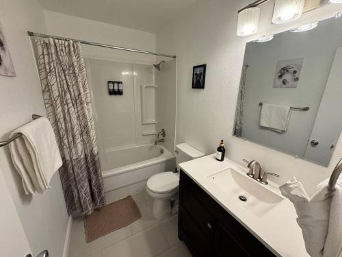 a bathroom with a sink and a toilet and a shower at 4BR Luxury, Walk to Old Town, Arcade, Pool, 12 Guests in Scottsdale