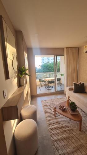 a living room with a couch and a table at Apartamento de Lujo - Condominio Santa Marina in Santa Marta