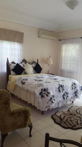 a bedroom with a large bed and a chair at Kingston Studio Apartment in Kingston