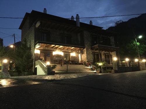a building with lights on the front of it at night at Asimina Guesthouse, Eptalofos Parnassos in Eptalofos