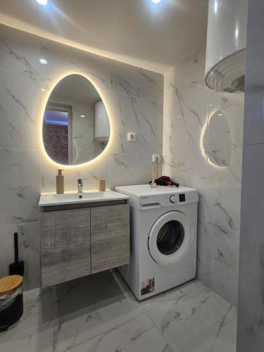 a bathroom with a washing machine and a sink at Chrysalis House in Nea Potidaea