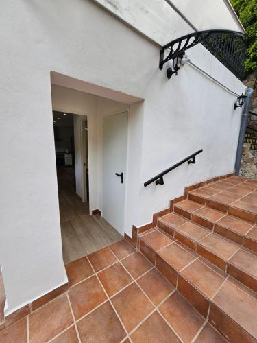 a stairway leading up to a white building with a door at Confort House in Argentona