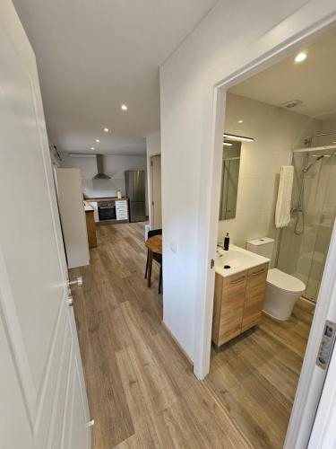 a bathroom with a sink and a toilet and a mirror at Confort House in Argentona