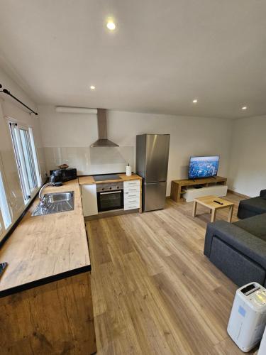 a large kitchen and living room with a couch and a kitchen and a kitchen at Confort House in Argentona