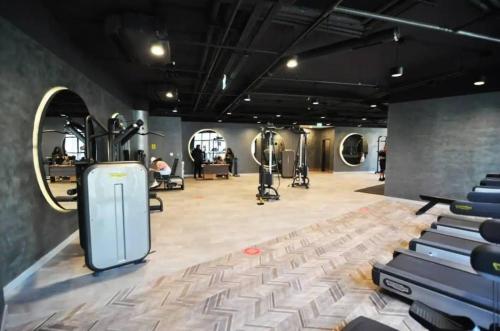 a gym with rows of exercise equipment in a room at Gorgeous Modern 1bd Condo Views W Poolgym! #255 in Istanbul