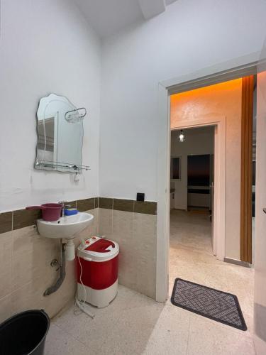 a bathroom with a sink and a toilet and a mirror at Sunset Vibes Larache in Larache