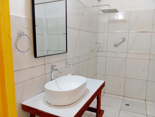 a bathroom with a white sink and a shower at Native Heart Amazon Lodge in Shapaja