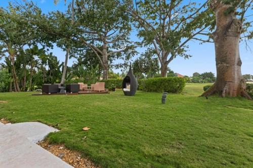 a park with a sculpture in the grass at Villa with golf course views in San Rafael del Yuma