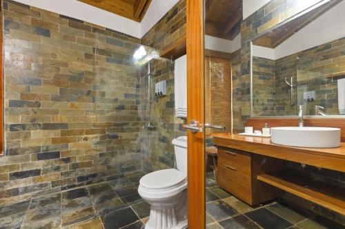 a bathroom with a toilet and a sink at Villa with golf course views in San Rafael del Yuma