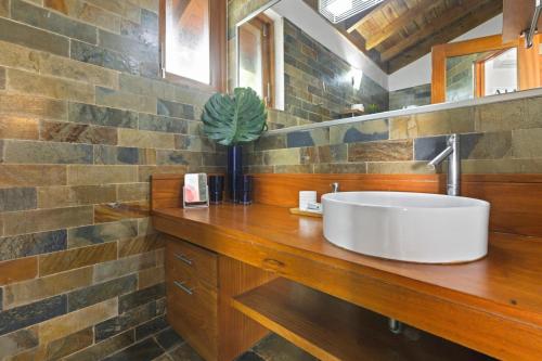 a bathroom with a white sink on a wooden counter at Villa with golf course views in San Rafael del Yuma