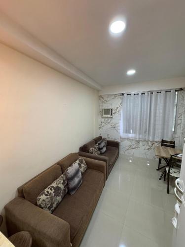 a living room with a couch and a table at Angra inn, Angra dos Reis in Angra dos Reis