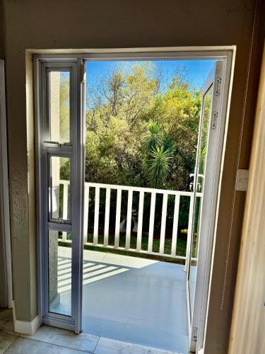 an open door with a view of a balcony at Wellness Guesthouse in Krugersdorp