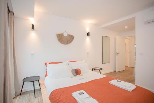 a bedroom with a bed with two scales on it at Liiiving in Gaia - Cooper Residence Apartment II in Vila Nova de Gaia