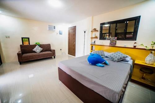 a bedroom with a blue stuffed animal sitting on a bed at Beach house at lobo in Lobo
