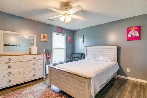 a bedroom with a bed and a dresser and a fan at Residential Cul-De-Sac Suburban Memphis Hideaway! in Lakeland