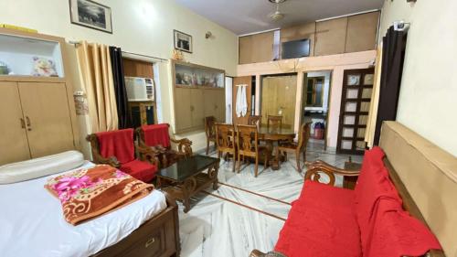 a living room with a couch and a dining room at Kusum Palace in Varanasi