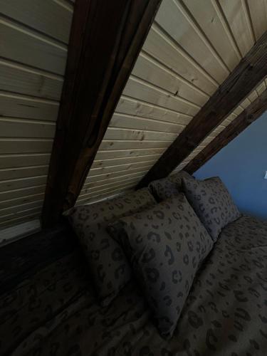 a bed with two pillows in a room with a ceiling at Shalash 1 in Velikiye Lazy