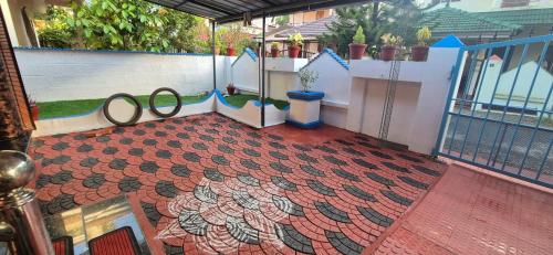 a balcony with two pairs of scissors on a tile floor at Brundhavan - Peaceful villa in Kottayam in Kottayam