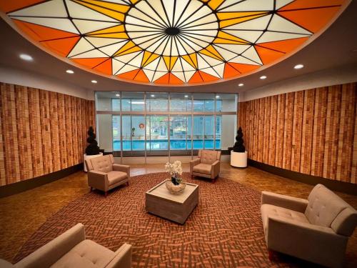 a large lobby with a large stained glass ceiling at Lower Penthouse Suite with Pools & Sunset Views in Toronto