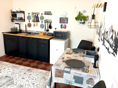 a small kitchen with a table and a refrigerator at Lake Como Windrose - Rosa dei Venti in Bellano