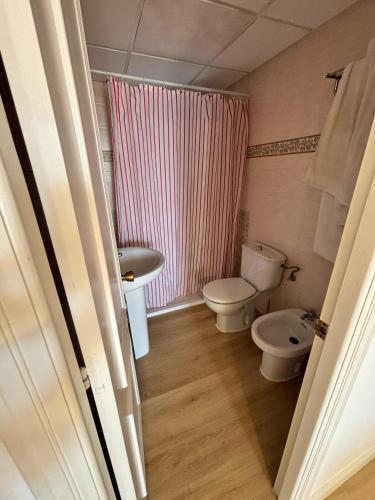 a bathroom with a white toilet and a sink at Apartamento 313 Castell Sol CB in Arenal d'en Castell