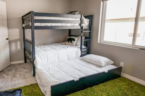 a bedroom with two bunk beds and a window at The Pine House in Flagstaff