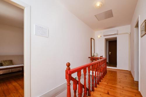 a staircase in a house with a stair case at Kapetanova kuća in Martinšćica