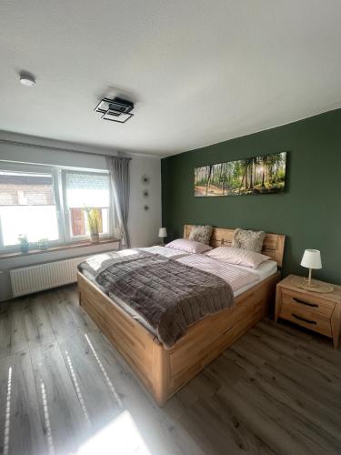 a bedroom with a large bed and green walls at Eifeltraum Mendig, 3 Sterne, Ferienwohnung in Mendig