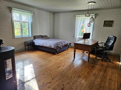 a bedroom with a bed and a desk with a computer at Beautiful house in Fränsta in Fränsta
