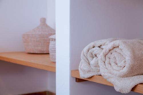 a towel is sitting on a wooden shelf at Mar-Ria 1 in Fuzeta