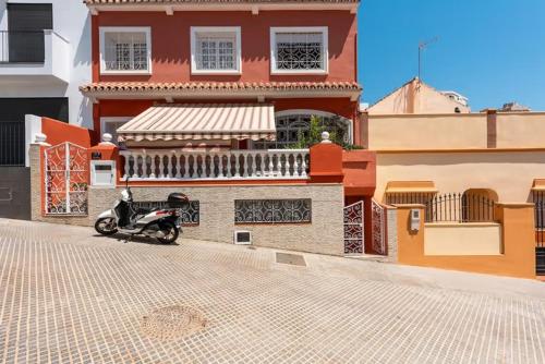 a motorcycle parked in front of a building at Malaga jacuzzy in Málaga